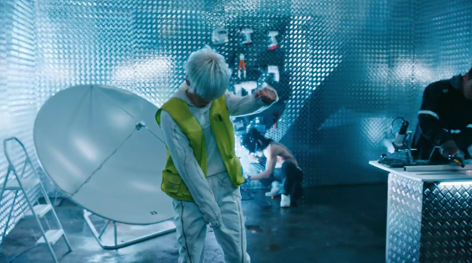 a man standing in front of a satellite dish