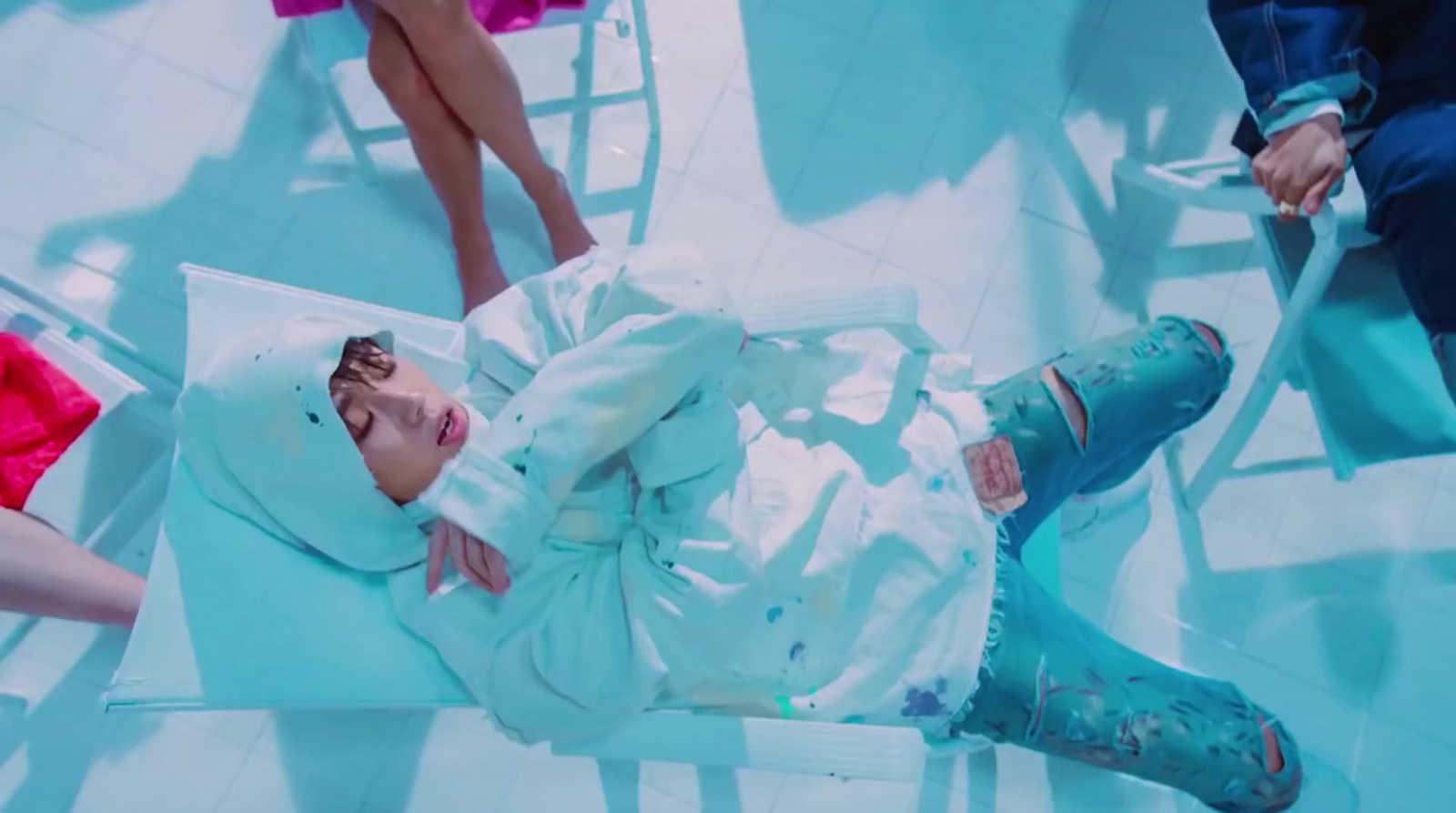 a young child laying on top of a white sheet