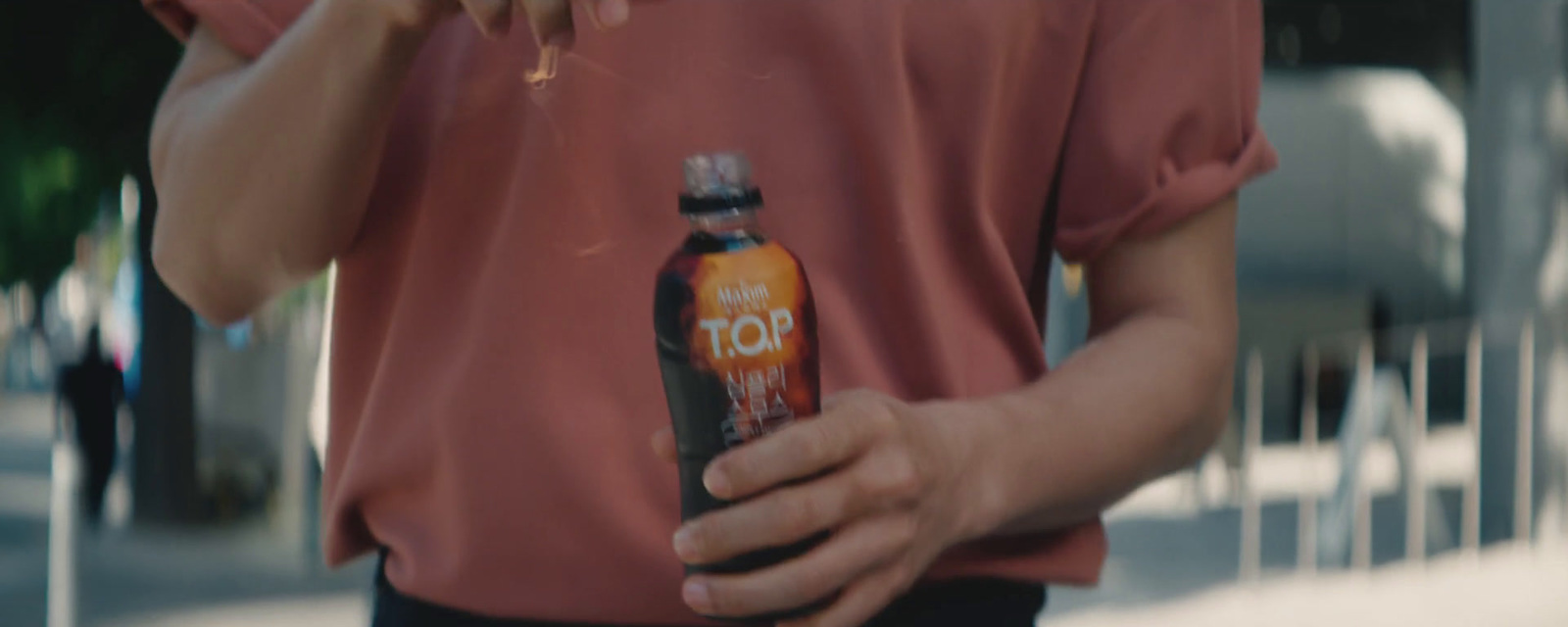 a man in a red shirt is holding a beer