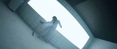 a woman in a white dress is standing in a room