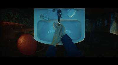 a person's hands are holding a faucet in front of a sink