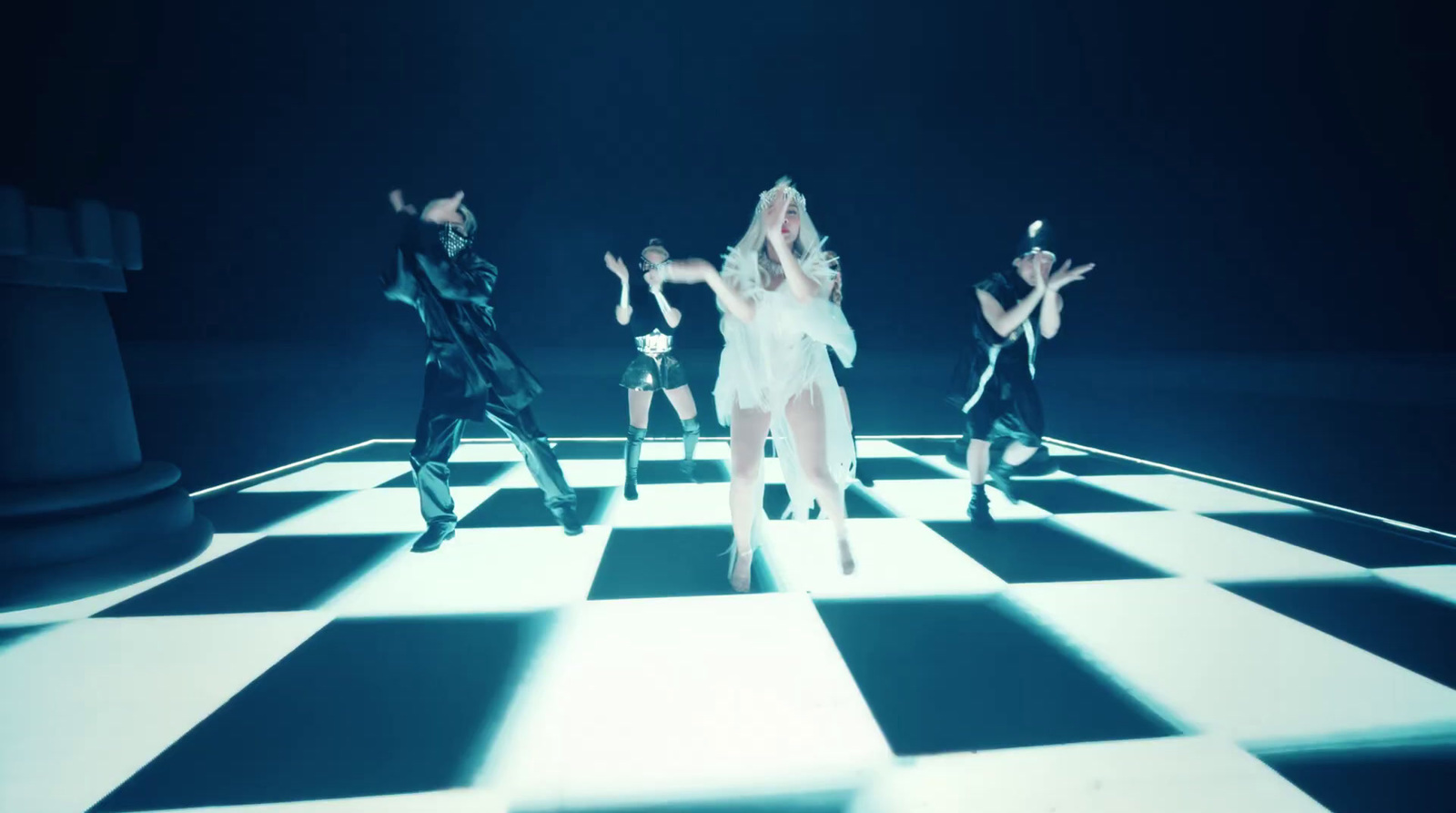 a group of people standing on top of a checkered floor