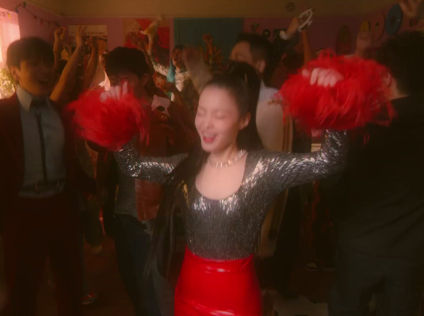 a woman in a silver and red dress dancing