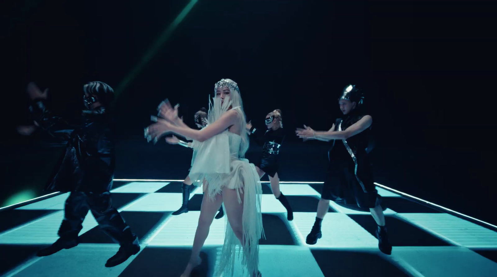 a woman in a white dress dancing on a checkered floor