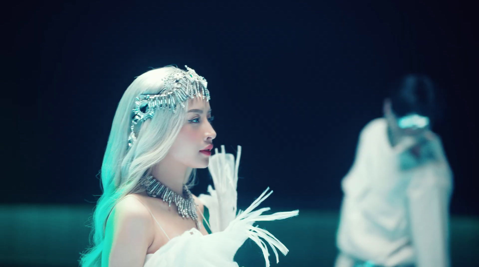 a woman in a white dress and a man in a white suit