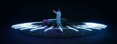 a man standing on top of a car in the dark