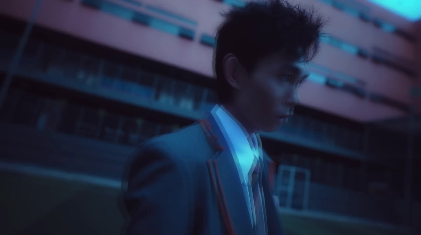 a man in a suit and tie standing in front of a building