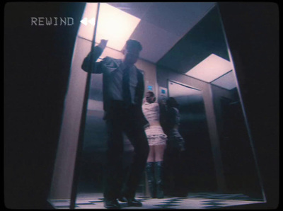 a man and a woman standing in an elevator