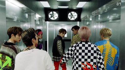 a group of young men standing in a elevator