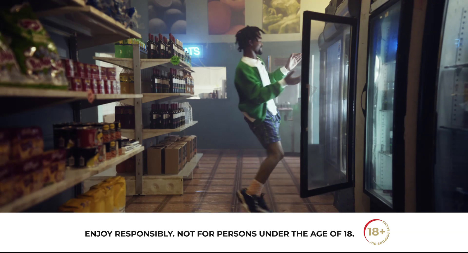 a man standing in front of a refrigerator in a store