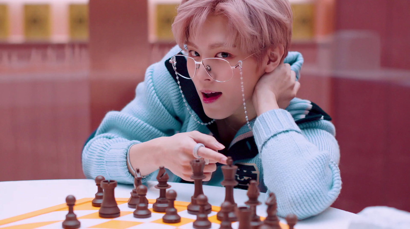 a boy playing a game of chess on a table