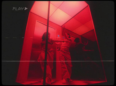 a couple of people standing in a red room