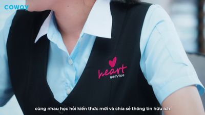 a woman wearing a black vest and a blue shirt