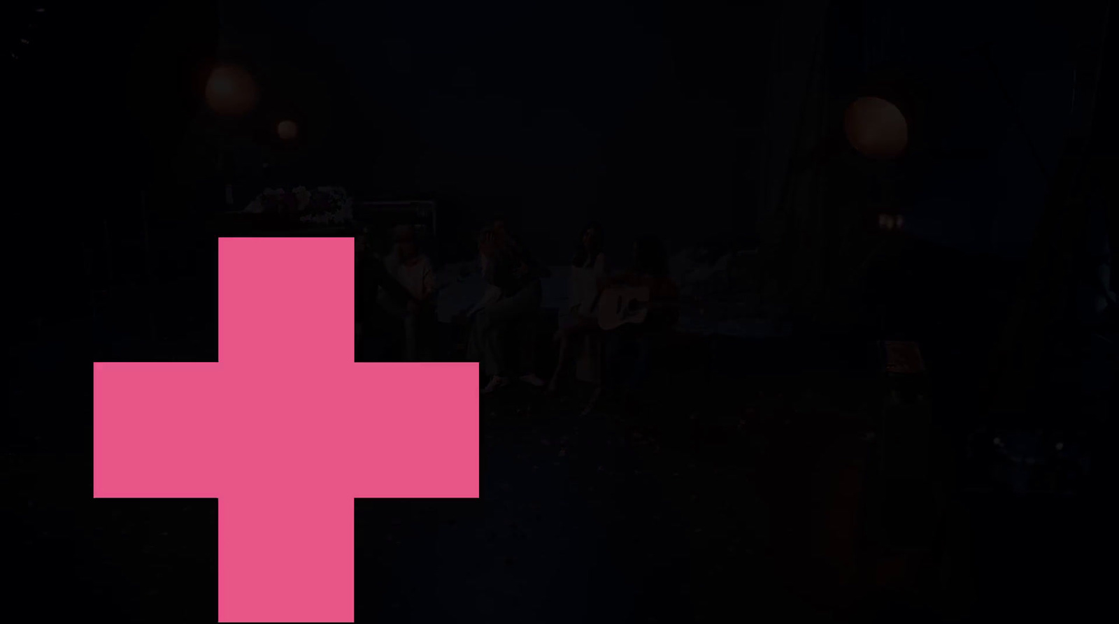 a pink cross on a black background