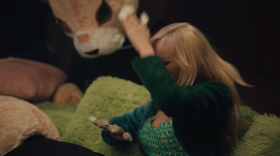 a little girl playing with a stuffed animal