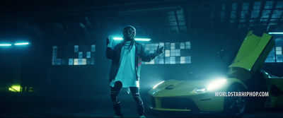 a man standing next to a yellow sports car