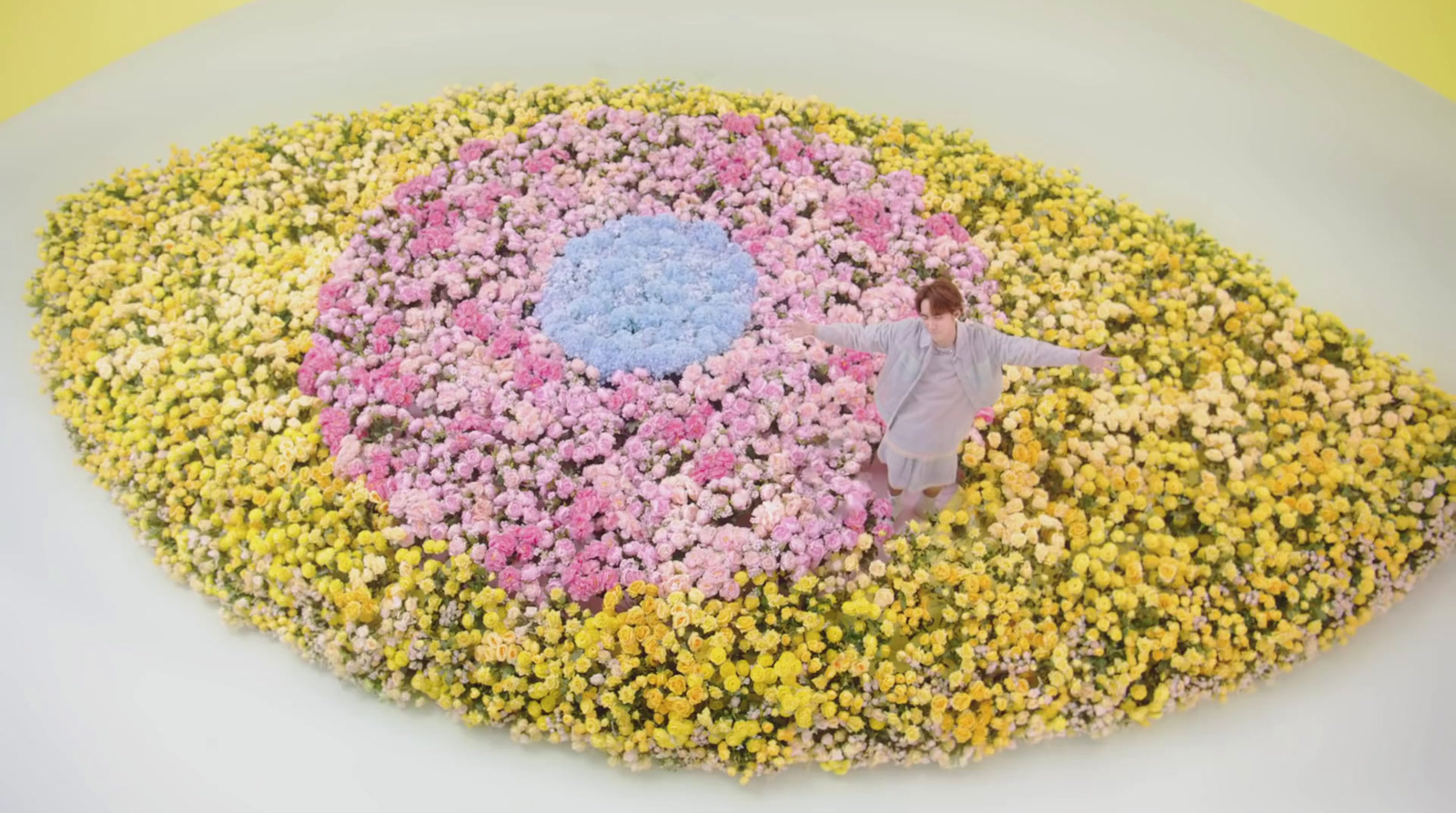 a woman standing in a field of flowers