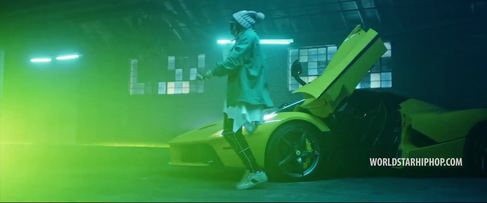 a man standing next to a yellow sports car