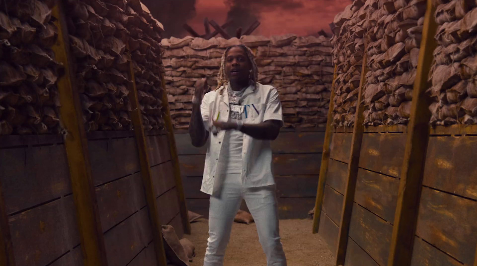 a man standing in a room with stacks of bricks