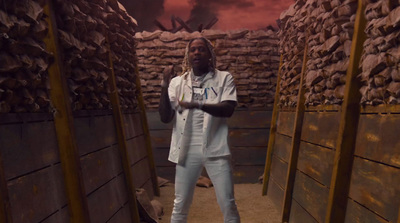 a man standing in a room with stacks of bricks