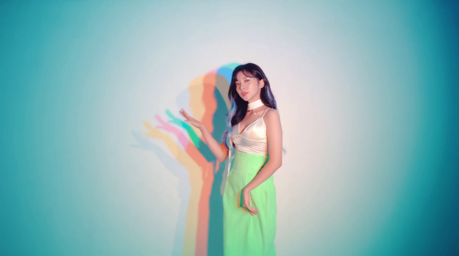 a woman standing in front of a blue wall