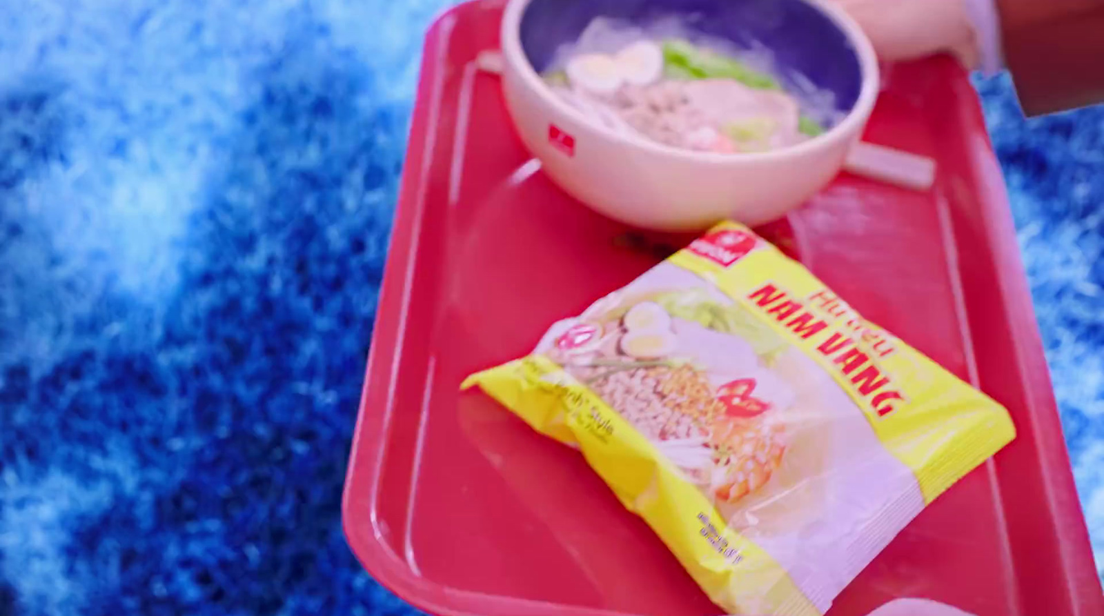 a tray with a bowl of rice and a bag of chips