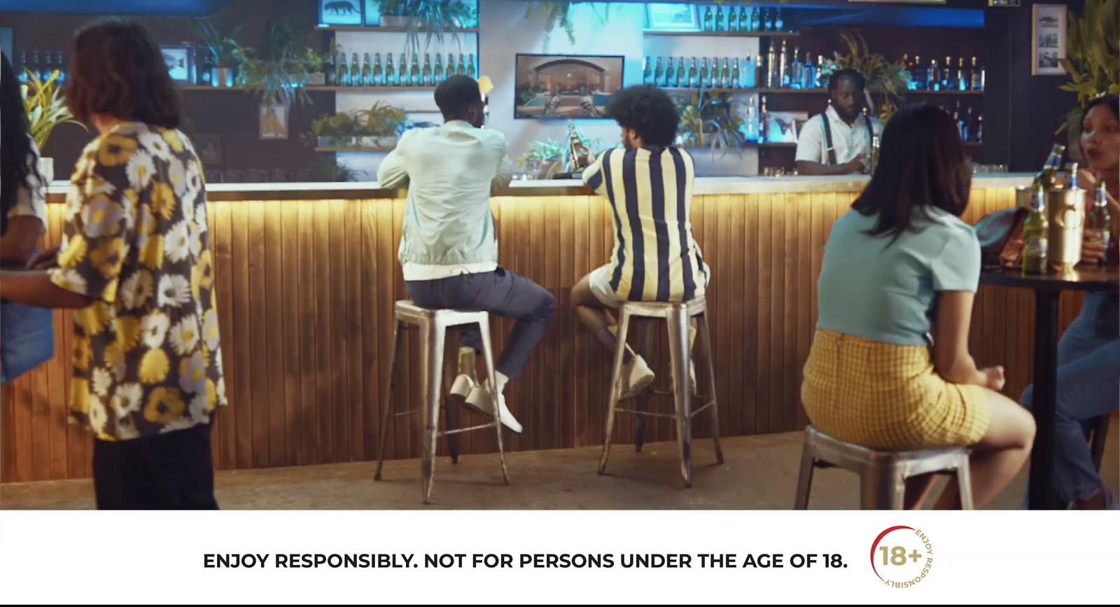 a group of people sitting at a bar