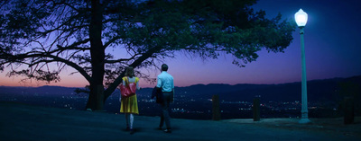 a man and a woman standing next to each other under a tree