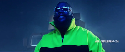 a man wearing a neon green jacket and sunglasses