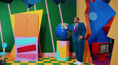 a man standing in front of a colorful wall