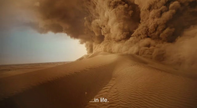 a large plume of smoke billowing out of a desert