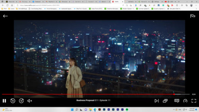 a person standing on a balcony overlooking a city at night