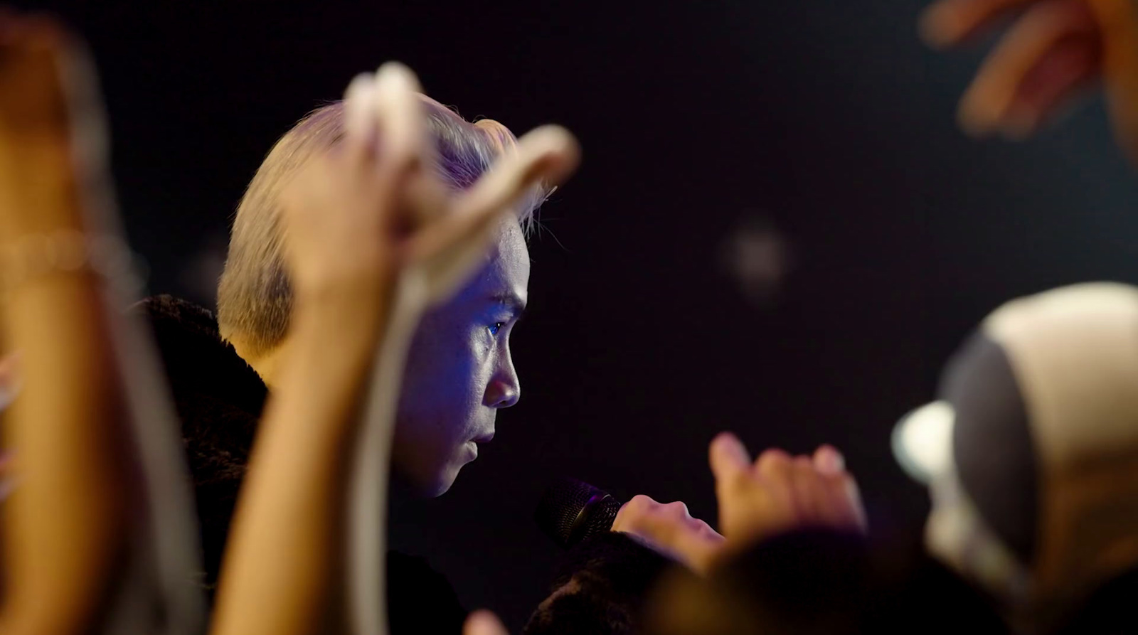 a group of people raising their hands in the air
