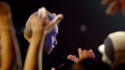 a group of people raising their hands in the air