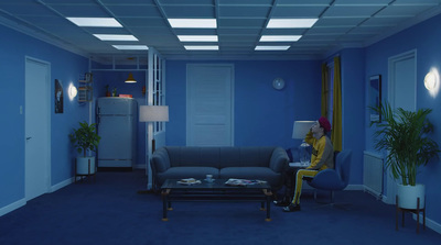 a woman sitting on a couch in a blue room