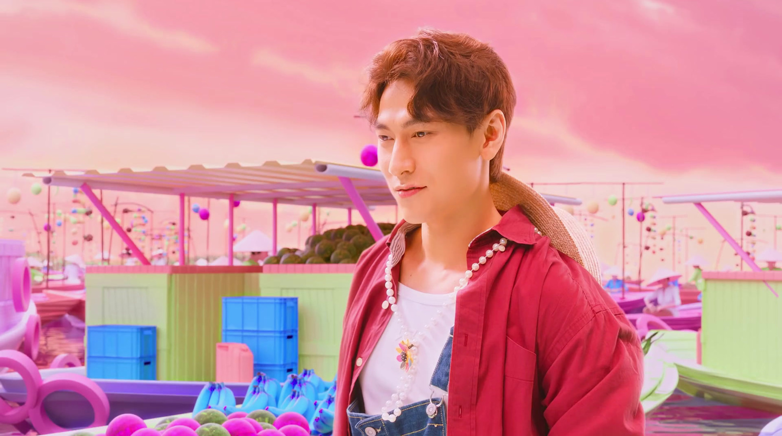 a young man standing in front of a carnival ride