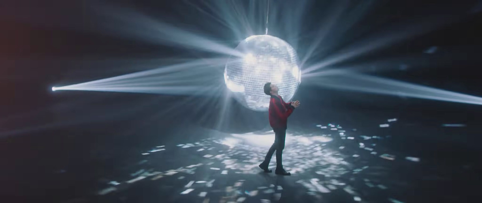 a person standing in front of a disco ball