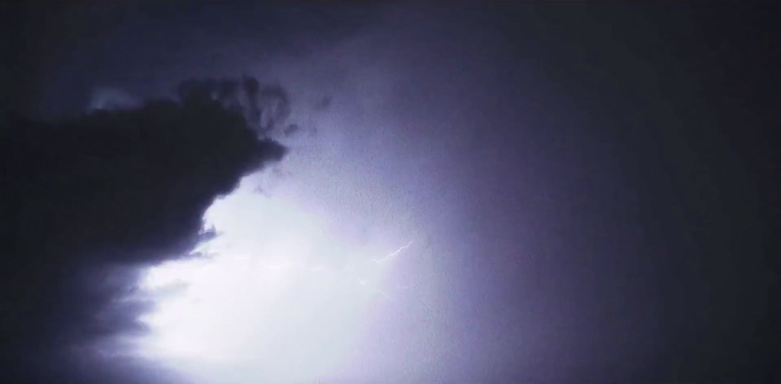 a large cloud with a lightning bolt coming out of it