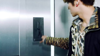 a woman is standing in front of a stainless steel door