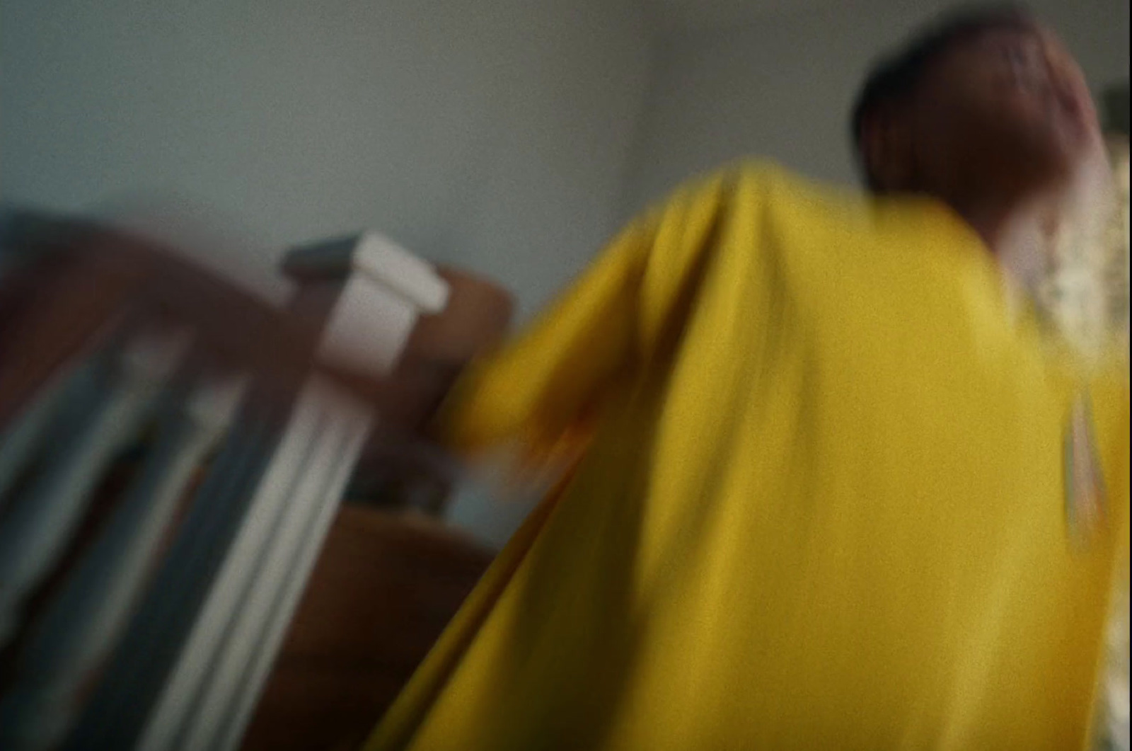 a blurry photo of a man in a yellow shirt