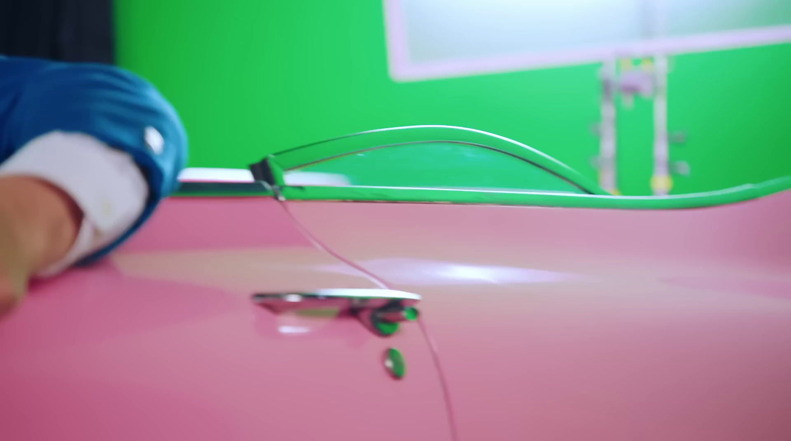 a pink car with a green screen behind it