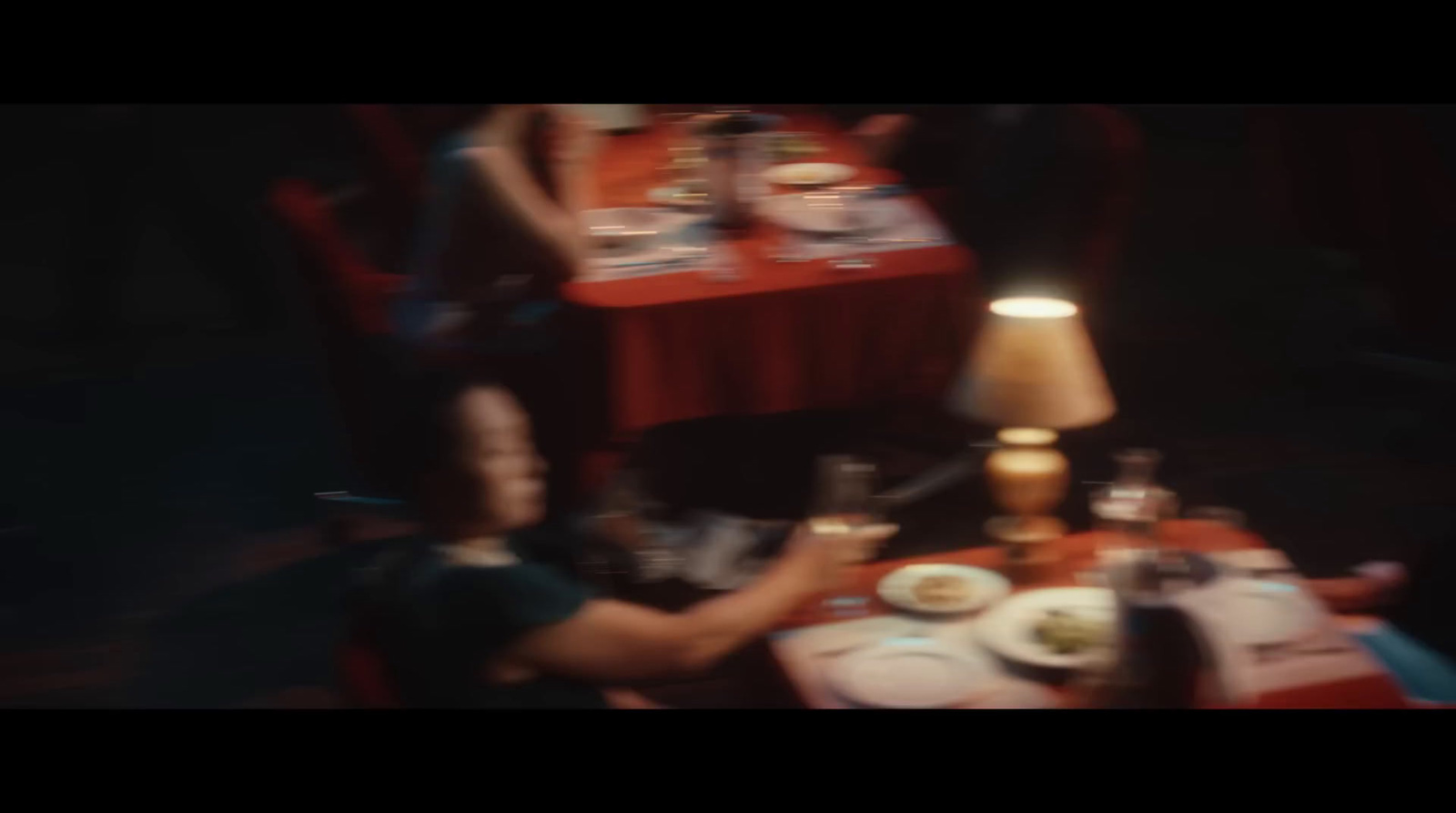 a woman sitting at a table with plates of food