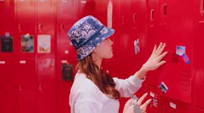 a woman is putting her hand in a locker