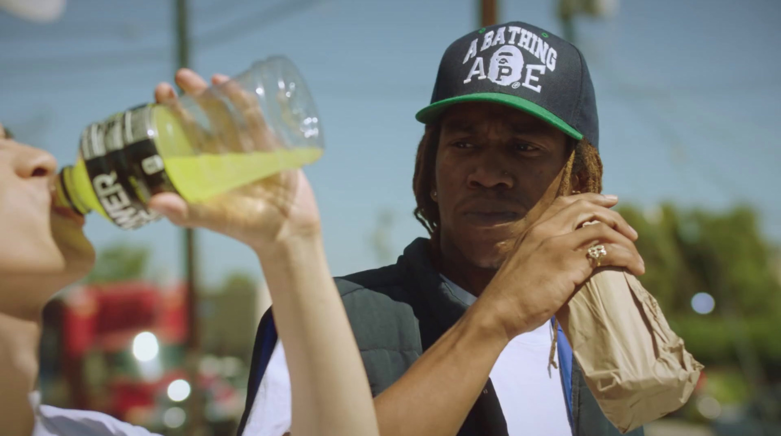 a man and a woman drinking from a water bottle