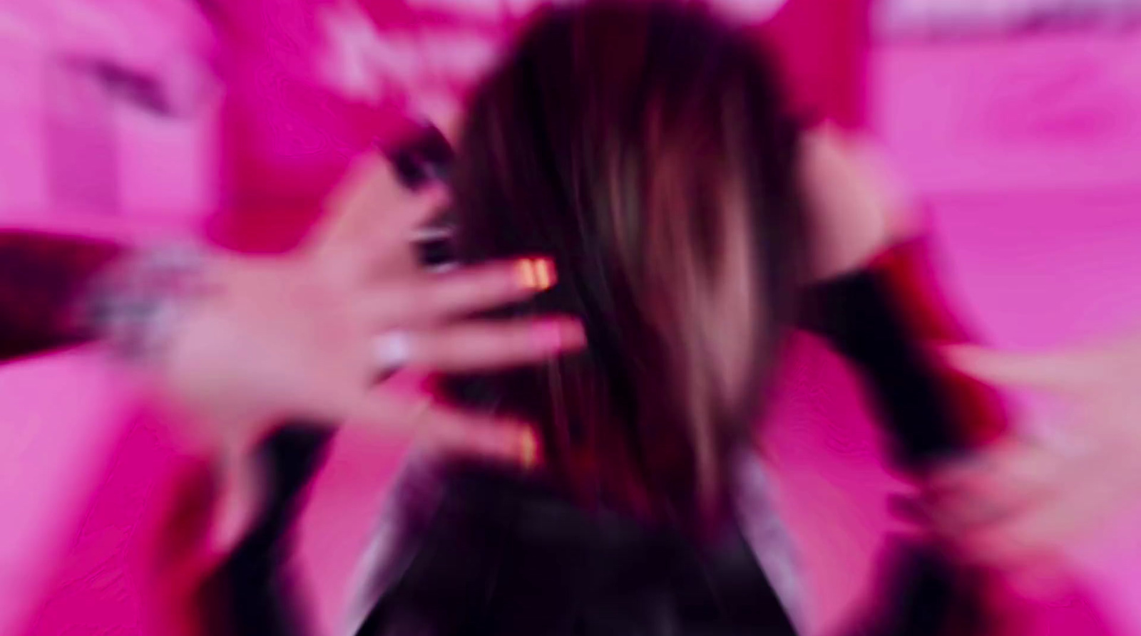 a blurry photo of a woman holding a cell phone