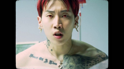 a man with red hair and piercings making a face