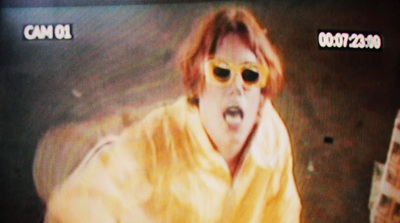 a man wearing sunglasses and a yellow robe