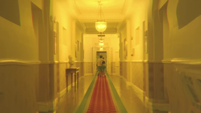 a long hallway with a red and green carpet