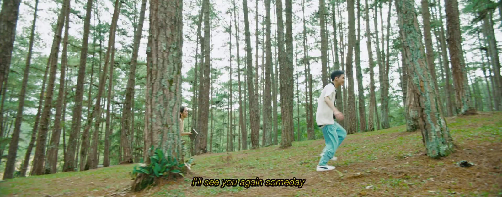 a man standing in the middle of a forest