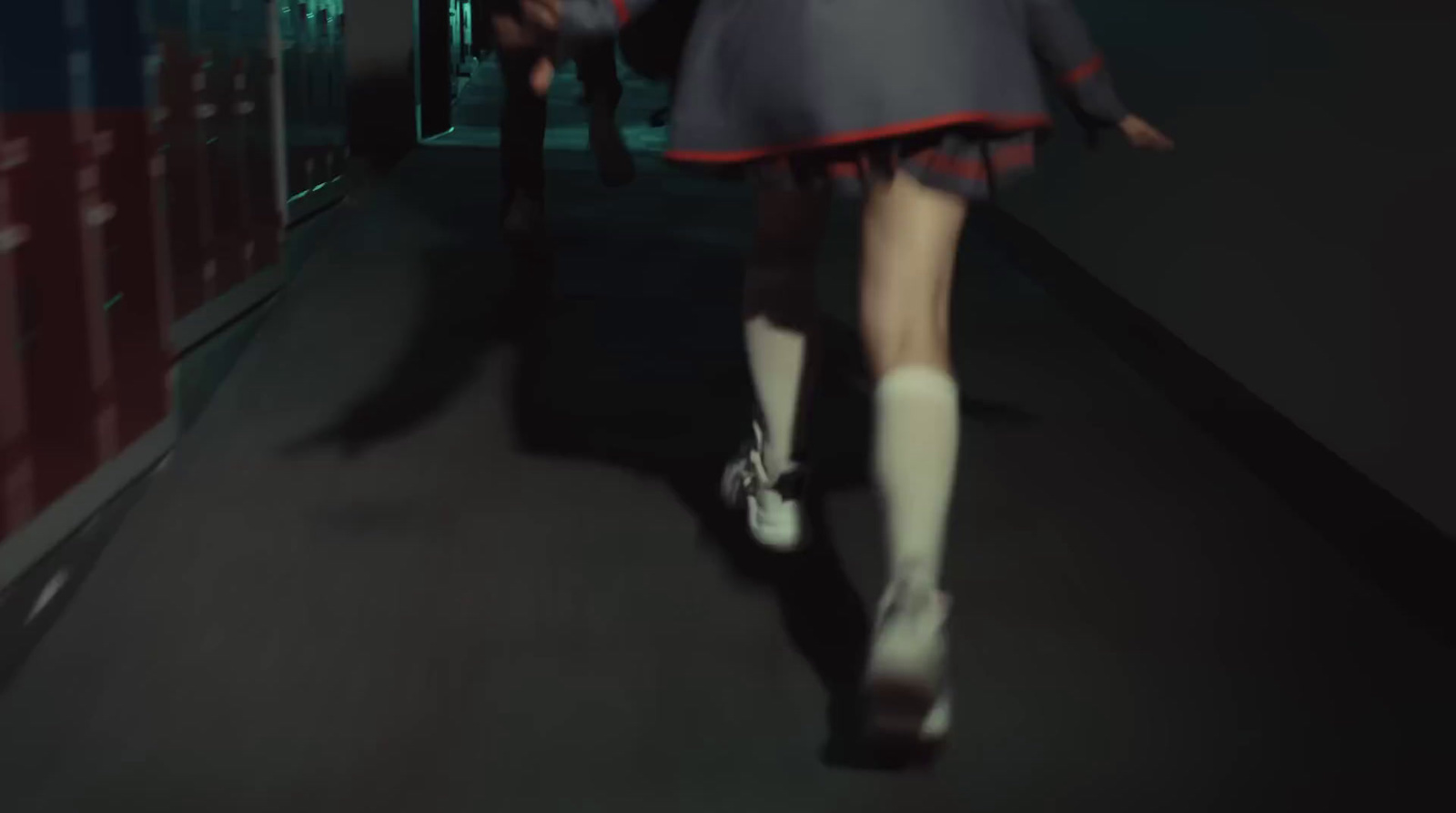 a woman walking down a hallway in a school uniform